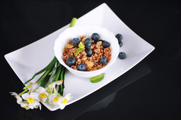 A healthy breakfast cereal with milk and fruit. Oat and corn flakes with chocolate and yogurt. The concept of healthy and vegetarian food.