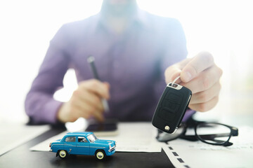 The insurance agent signs a document. Car insurance policy. Auto insurance policy. Forms for registration of the contract.