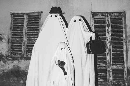 Family of ghosts in front of their home
