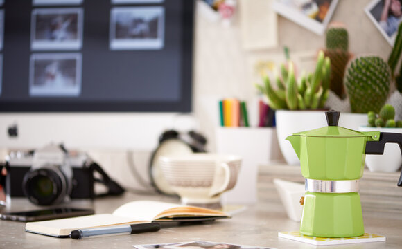 Green coffee pot on desktop