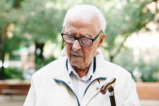 Portrait of an elderly man standing outside.