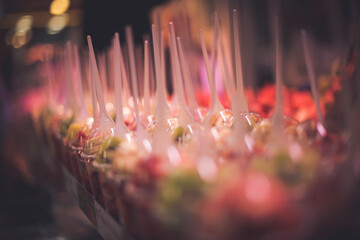 Selective focus shot of sliced fresh fruits in plastic cups in a market