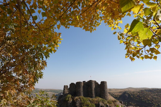 Ancient fortress Amberd in Armenia framed by yellow leaves