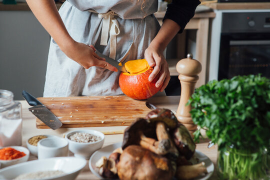 Woman Hollows Out a Pumpkin