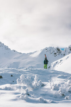 male skier standing in snowcovered alpine winter landscape