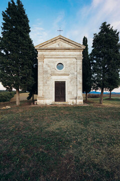 little white church with cypresses