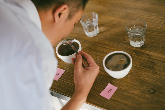 Young man making experiment on coffee and comparing
