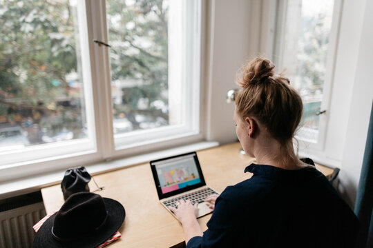 Woman sitting at desk on computer