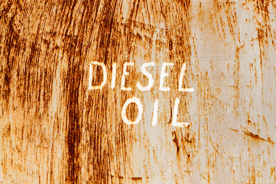 Diesel Oil"" sign in white paint on a rusted barrel