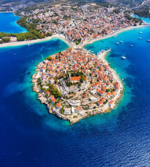 Primosten town, Croatia. View of the city from the air. Seascape with beach and old town. View from drone on the peninsula with houses. Landscape during sunset. Travel image
