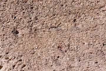 A wall made up of sand along with holes in it