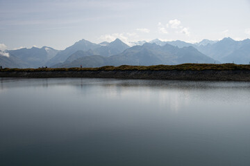 Fototapeta na wymiar artificial lake with the Austrian Alps in the background