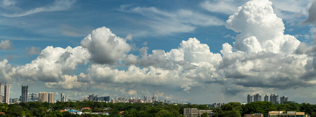 Panoramic landscape of city skyline with beautiful white clouds and blue sky