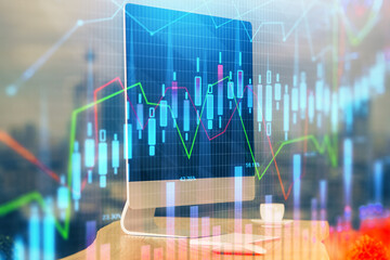 Financial graph colorful drawing and table with computer on background. Double exposure. Concept of international markets.