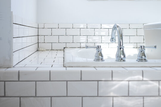 A newly tiled bathtub surround awaits completion