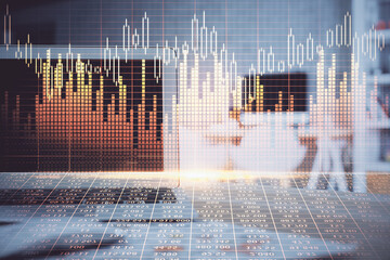 Double exposure of forex chart and work space with computer. Concept of international online trading.