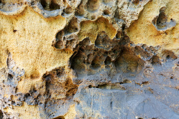 Close-up of holey natural sandstone rocks. Sandstone background