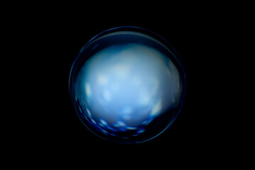 Blurry image of a shiny crystal ball with abstract blurry colorful pattern. Abstract lensball in blur.