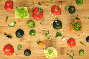 Abstract still life with vegetables trash on bamboo kitchen board top view closeup