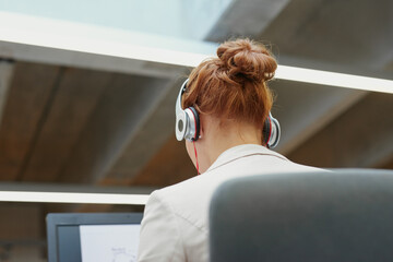 Red head business woman working at desk
