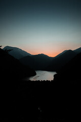 Panorama of beautiful mountain lake in the sunset light, lake Ritsa in the Caucasus Mountains, in the north-western part of Abkhazia, Georgia
