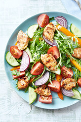 Healthy Salad with Chicken Breast, Cherry Tomatoes, Cucumber, Orange Pepper, Endive and Red Onion. Top view.	