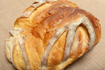 Homemade Brazilian corn bread. Isolated on jute background.