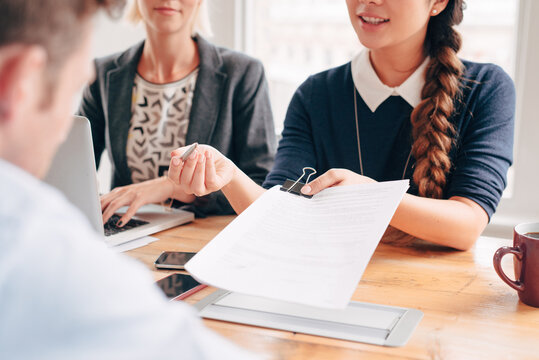 Close up businesswoman hands pointing to legal document for signing