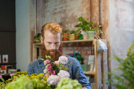 A florist arranging a flower bouquet in his shop