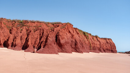 Woman sitting at a red sand dune