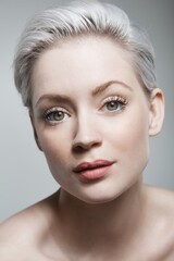 Fototapeta premium Closeup portrait of young blonde woman looking at camera. 