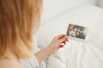 Young woman holding a lovers polaroid