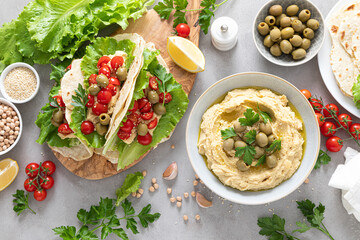 Tortilla wraps with chickpea hummus, fresh tomatoes and olives, vegan food