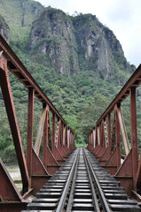 Obraz premium Railroad tracks crossing a bridge near Aguas Calientes in Peru, the gateway to Machu Picchu