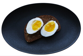 two halves of an egg on a piece of cereal bread