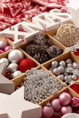 Christmas ornaments in wooden compartment with letters xmas. 