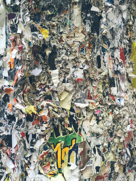 Layer upon layer of peeling posters on telephone pole, close up