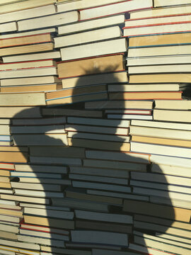 Stack of books and photographer's shadow