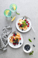 Pancakes with fresh blueberry and raspberry served for healthy vegetarian breakfast
