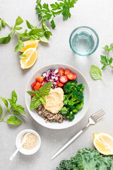 Vegetarian Buddha bowl with quinoa, vegetables and hummus, healthy food concept