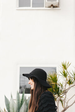 Girl Standing Next to Cactus Building