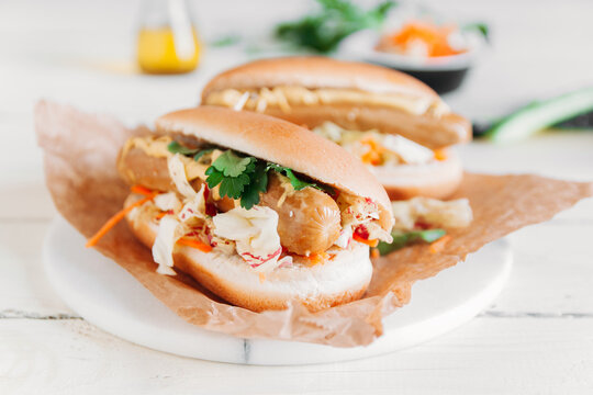 Two hot dogs with vegetables