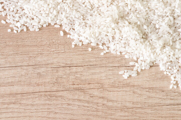 Fototapeta na wymiar Rice on a wooden background with place for text.
