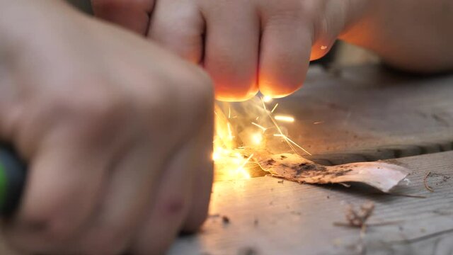 Producing sparks from a magnesium fire starter.