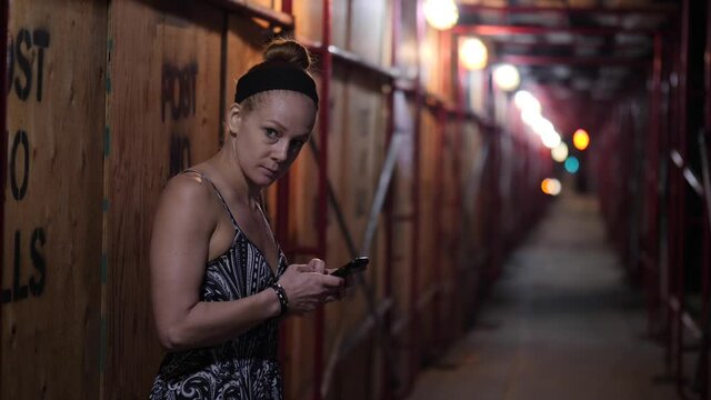 Redhead Woman worried with her Smartphone at night in Slow motion