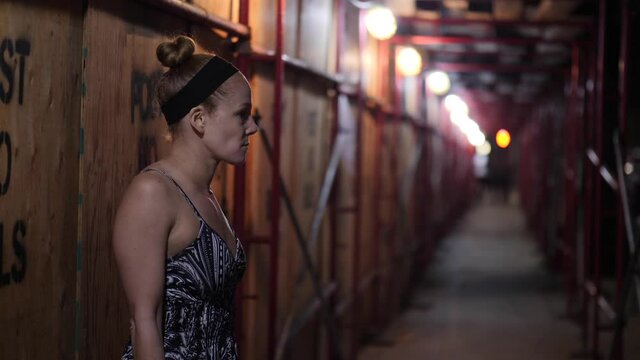 Redhead Woman alone in dark alleyway with her Smartphone