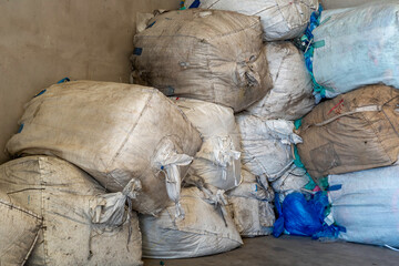 Recycle plastic, Big bag, which contains recycled plastic. They are stacked horizontally next to the warehouse walls to be transported to the plastic smelter.