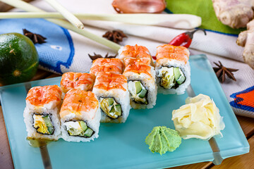 Hosomaki sushi rolls with shrimp, Philadelphia cheese and cucumber are on a plate