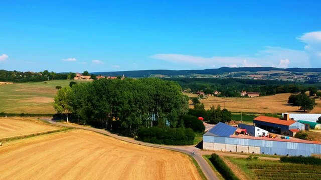 Fast backward moving shot of a field, brown color, near Taize village in France.