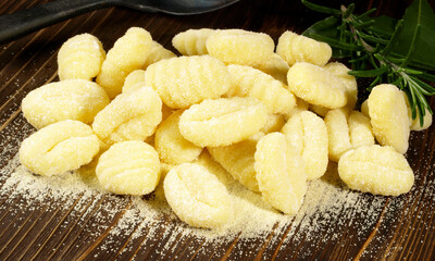 Uncooked Gnocchis on wooden Background